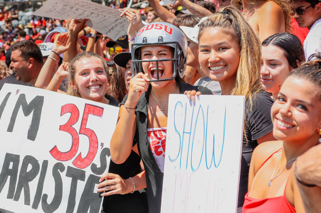 Students cheering at The Show at a football game.