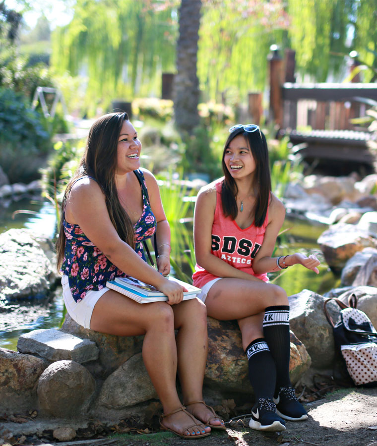students sitting at Scripps Cottage turtle pond