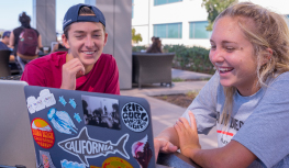 Two students watching their laptop.
